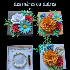 Puede incluir: Cuatro cajas de regalo con arreglos florales de papel. Las cajas están decoradas con flores de papel de colores en tonos rojos, naranjas, azules y blancos. Una caja contiene una pulsera y un frasco pequeño. El texto "Cadeau de fête des mères ou autres" está en la parte superior.