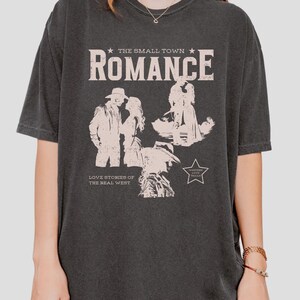 Comfort Colors Shirt in the Color pepper. Cowboy/Western Romance Book Shirt. Text:The small town romance, love stories of the real west, western love trails;.