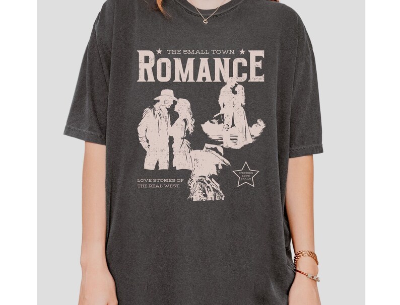 Comfort Colors Shirt in the Color pepper. Cowboy/Western Romance Book Shirt. Text:The small town romance, love stories of the real west, western love trails;.