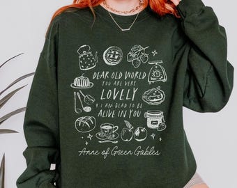 May include: Dark green sweatshirt with a white graphic design featuring food illustrations and the text "DEAR OLD WORLD YOU ARE VERY LOVELY + I AM GLAD TO BE ALIVE IN YOU" and "Anne of Green Gables".