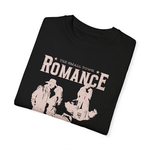 Comfort Colors Shirt in the Color black. Cowboy/Western Romance Book Shirt. Text:The small town romance, love stories of the real west, western love trails;.