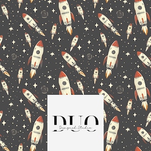 May include: A seamless pattern featuring white and red rockets on a dark gray background with white stars. The pattern is repeated throughout the image. The text "DUO Designed Studio" is in the center of the image.