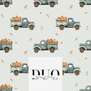 May include: A repeating pattern featuring watercolor illustrations of sage green vintage pickup trucks carrying wooden crates filled with orange pumpkins, interspersed with small brown autumn leaves on a light gray background. Text reads DUO Designed Studio.