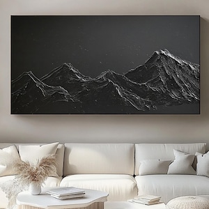 May include: A large rectangular wall art piece featuring a black mountain range with heavy, raised impasto texture. The painting depicts jagged peaks against a dark, solid background, creating a high-contrast, three-dimensional effect.