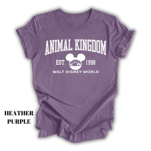 a purple shirt with an animal kingdom logo on it