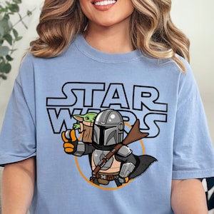 a woman sitting on a couch wearing a star wars shirt