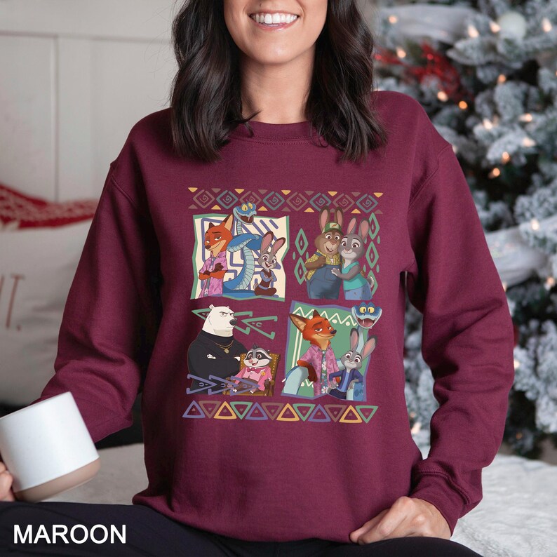 A woman wearing a burgundy sweater with a colorful graphic of cartoon characters from the animated film "Jumanji".