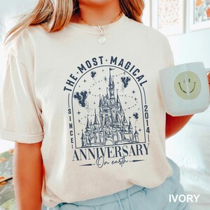 a woman holding a mug with a castle on it