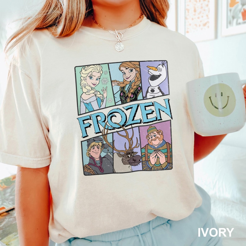 a girl holding a mug with frozen characters on it