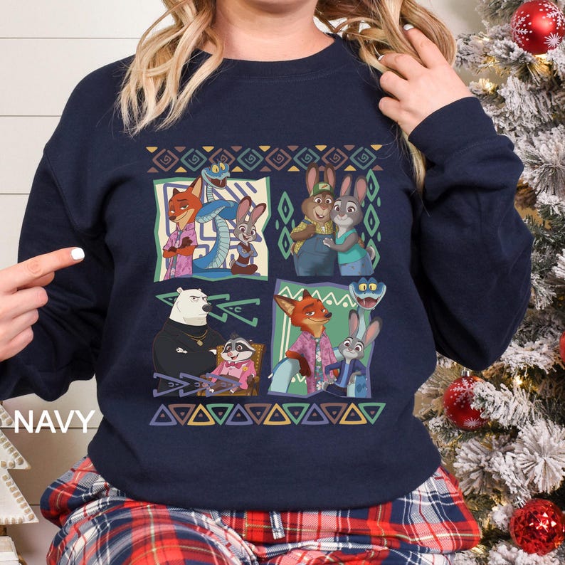 A woman wearing a navy blue sweatshirt with a colorful graphic design featuring cartoon animal characters.