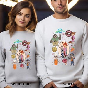 Two people wearing white sweatshirts with cartoon animal characters and various cartoon-style accessories printed on them.