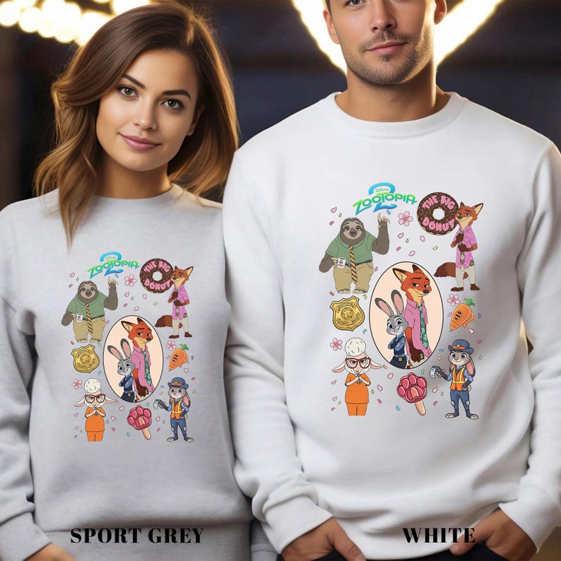 Two people wearing white sweatshirts with cartoon animal characters and various cartoon-style accessories printed on them.