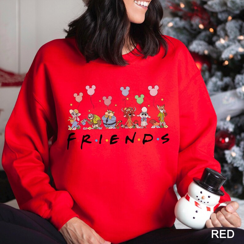 A woman wearing a red sweater with a graphic of Disney characters and the word "FRIENDS" printed on it.
