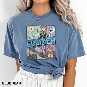 a woman wearing a blue shirt with frozen characters on it