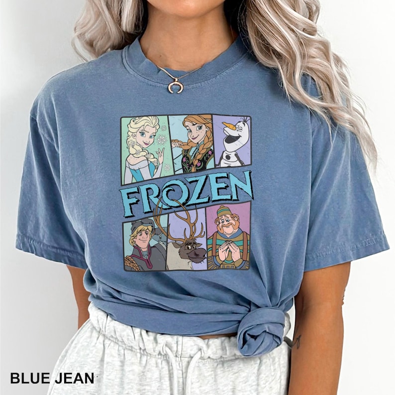 a woman wearing a blue shirt with frozen characters on it