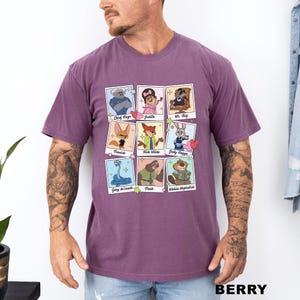 A man wearing a purple t-shirt with a graphic of cartoon characters from the Disney animated film "Jurassic Park".