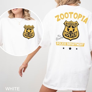 A white t-shirt with a police department logo and text, including the words "Zootopia Police Department" and "New Recruitment".