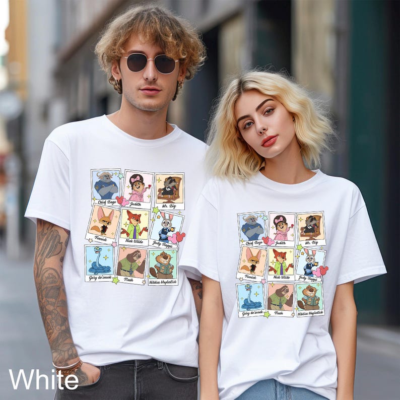 A man and a woman wearing white t-shirts with a collage of cartoon characters printed on them, standing together on a city street.