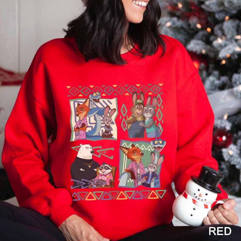A woman wearing a red sweater with a colorful graphic of cartoon animals, including a bear, foxes, and a snowman.