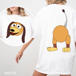 a woman wearing a t - shirt with a cartoon dog on it