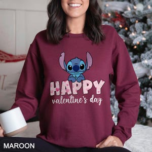 a woman wearing a happy valentine's day sweatshirt