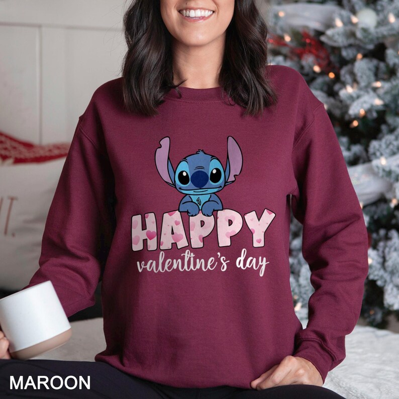 a woman wearing a happy valentine's day sweatshirt