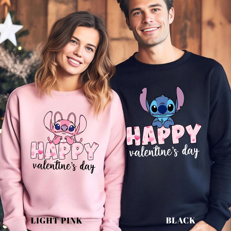 a man and woman wearing matching sweatshirts in front of a christmas tree