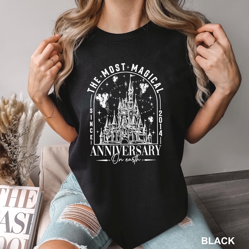a woman wearing a black shirt with a castle on it