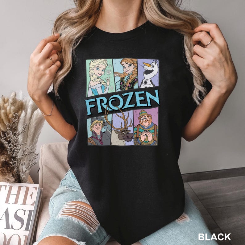 a woman wearing a black t - shirt with the words frozen on it