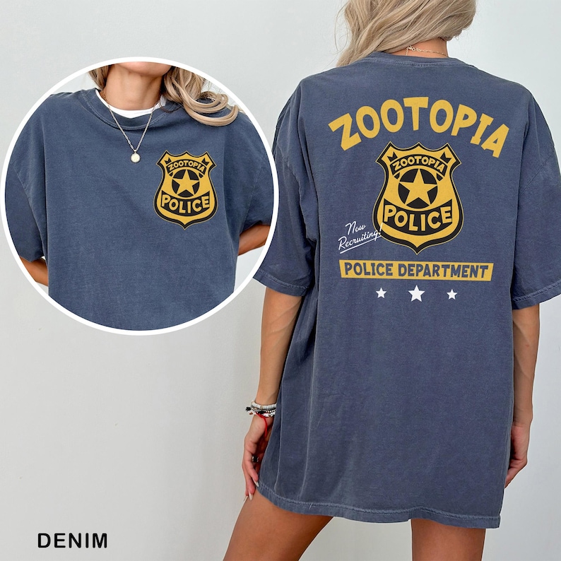 a person wearing a blue t-shirt with a yellow police badge and text on the back.