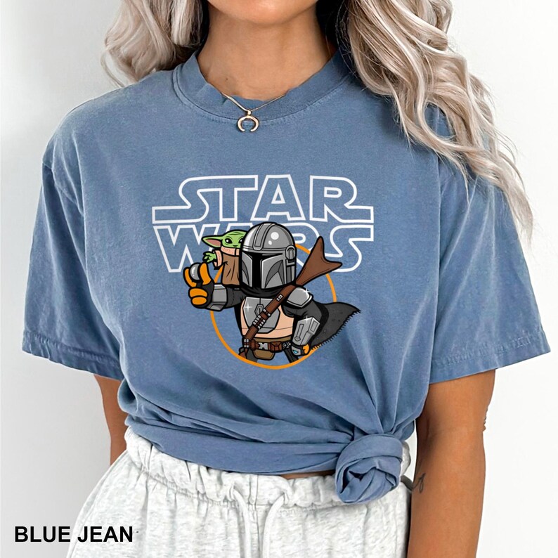 a woman wearing a blue star wars t - shirt