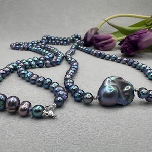 May include: A set of three ceramic mugs with a speckled, matte finish. The mugs are in shades of cream, light gray, and dark gray. Each mug has a simple, minimalist design and a rounded handle.