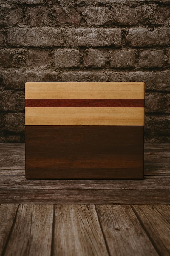 Maple, Padauk, and Walnut triple-wood combination makes a visually striking striped board, and the veteran-made story adds genuine meaning.