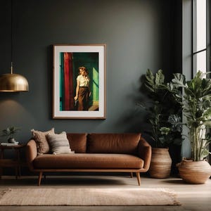 May include: A brown leather sofa with a framed print of a woman standing in a doorway. The sofa is in a living room with a large potted plant and a window in the background.