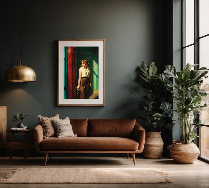 May include: A brown leather sofa with a framed print of a woman standing in a doorway. The sofa is in a living room with a large potted plant and a window in the background.