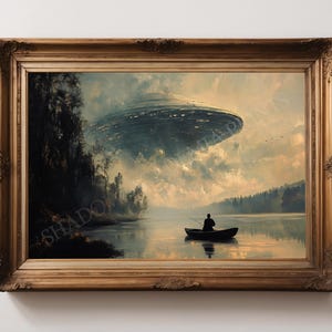 May include: A framed painting depicting a man in a boat on a lake, with a large, unidentified flying object hovering above. The scene is painted in a realistic style with muted colours.