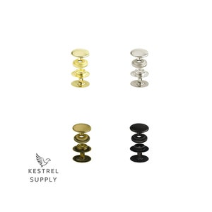 Puede incluir: Cuatro juegos de botones a presión de metal, cada juego consta de tres piezas. Los juegos son en oro, plata, negro y níquel.