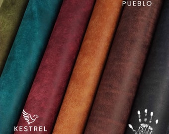 May include: Close-up of six different colored leather samples. The leather is textured and has a rustic look. The samples are arranged in a row, with the darkest leather on the right and the lightest leather on the left. The leather is labeled "PUEBLO".