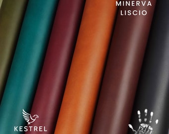 May include: Close-up of six different colored leather rolls. The rolls are arranged in a row from left to right, with the darkest color on the left and the lightest color on the right. The leather is smooth and has a slight sheen. The text "MINERVA LISCIO" is printed on the rightmost roll. The text "KESTREL SUPPLY" is printed on the leftmost roll.