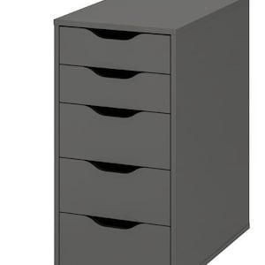 May include: A dark gray storage unit featuring five stacked drawers. Each drawer is equipped with a semi-circular cutout handle located at the top center. The unit has a rectangular frame with a flat top surface and sits on small, low-profile feet.