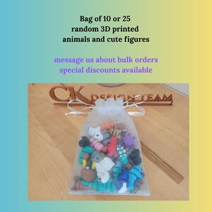 May include: A white mesh bag filled with colorful, random 3D-printed animal and figure toys. The bag is tied with a white ribbon. Text on the image reads: "Bag of 10 or 25 random 3D printed animals and cute figures."