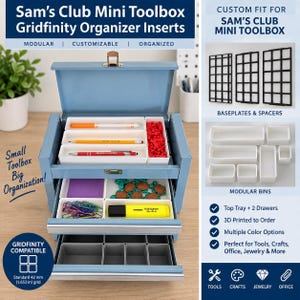 May include: A light blue metal toolbox with open drawers and lid, containing white modular gridfinity organizer inserts. The inserts hold pens, a highlighter, paper clips, and small items. Text includes Sam's Club Mini Toolbox Gridfinity.