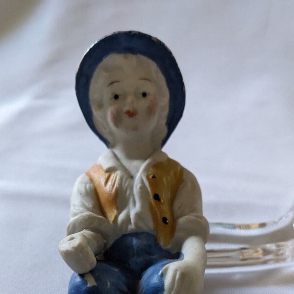 5" Bisque Boy Sitter, Molded, Made in Japanon bottom of seat, Blue hat and pants