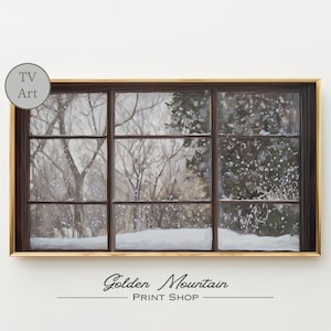 May include: A framed print of a winter scene viewed through a window. The window has a dark brown frame and a gold border. The winter landscape features snow-covered trees and a snowy ground. The print has the text "Golden Mountain Print Shop".