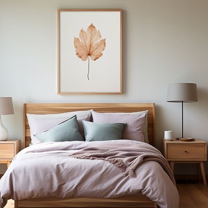 May include: A bedroom scene featuring a bed with light purple bedding, pillows, and a wooden headboard. Two wooden nightstands with lamps flank the bed. A framed print of a leaf hangs above the bed, and a wooden wardrobe is visible.
