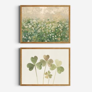 May include: Two framed prints with a nature theme. The top print features a field of white flowers with green foliage. The bottom print features a cluster of green shamrock leaves.