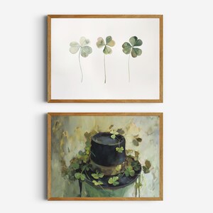 May include: Two framed prints, one with three green four-leaf clovers, the other with a black top hat with green four-leaf clovers on top, against a green and white background.