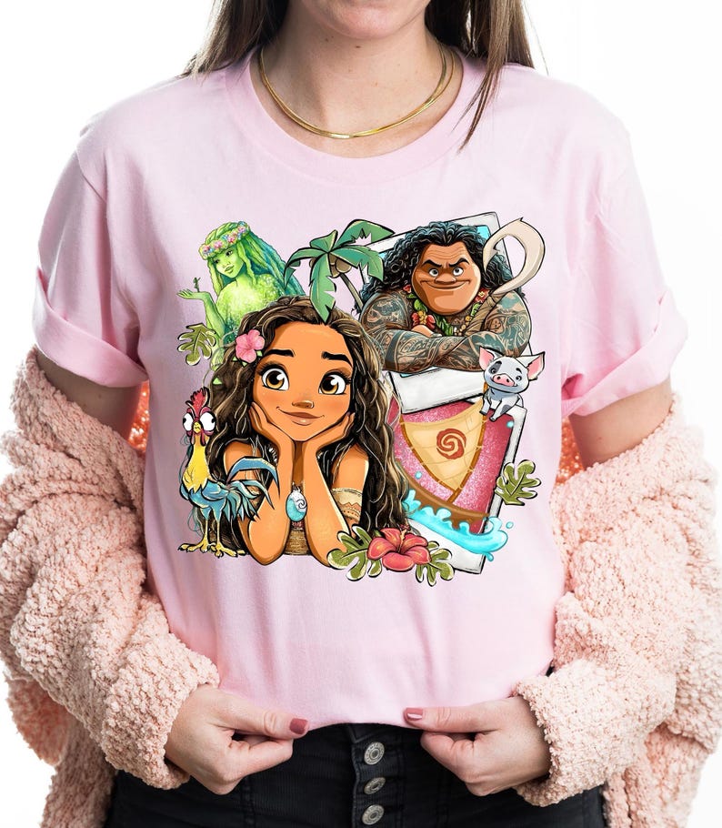 May include: Pink t-shirt featuring a colorful graphic of characters from a popular animated movie. The design includes a central female character with long brown hair, surrounded by other characters and tropical elements.