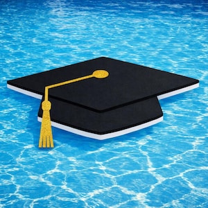 May include: A black graduation cap with a gold tassel floats on blue water. The cap has a white border and a gold glitter accent on the top. The water has a rippled effect.