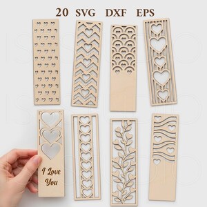 May include: A collection of eight wooden bookmarks with various heart and floral cut-out designs. One bookmark has the text "I Love You". The image also includes the text "20 SVG DXF EPS".